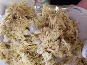 image shows how to shred chicken for meal prep